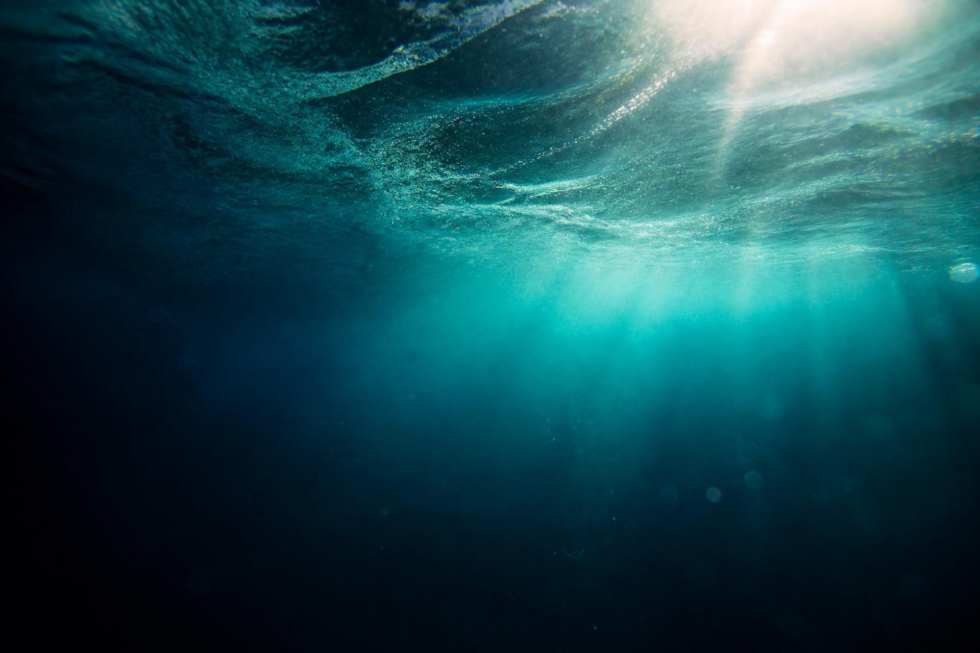 Sunlight filtering through deep teal ocean water